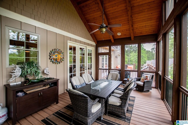 sunroom / solarium with french doors, outdoor dining area, ceiling fan, and beam ceiling