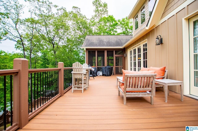 wooden deck with a sunroom and an outdoor hangout area
