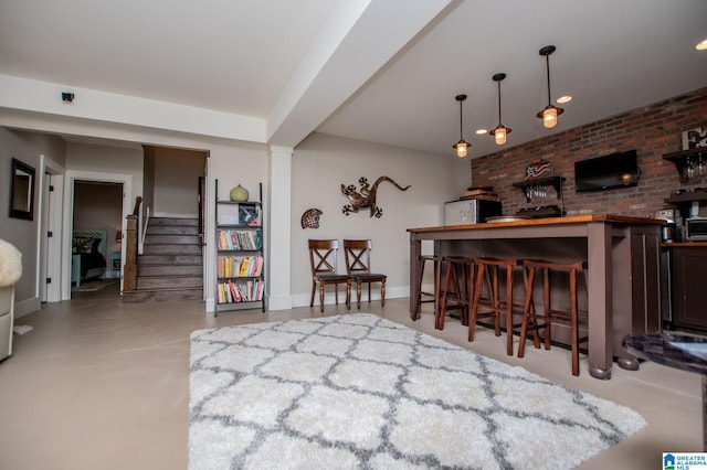 bar featuring stairway, finished concrete flooring, and pendant lighting