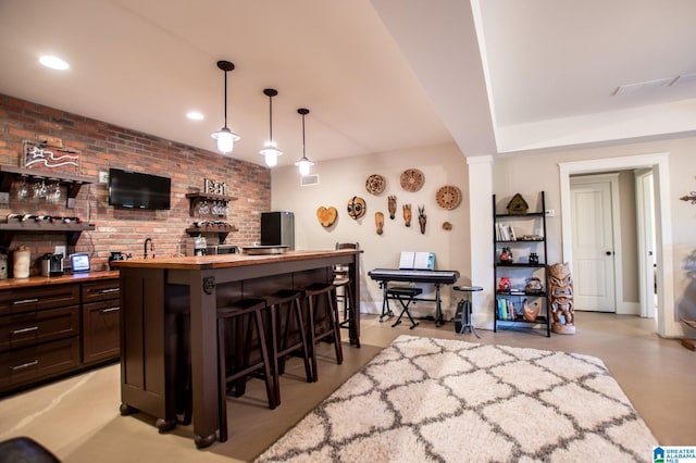 bar featuring visible vents, brick wall, indoor wet bar, recessed lighting, and hanging light fixtures
