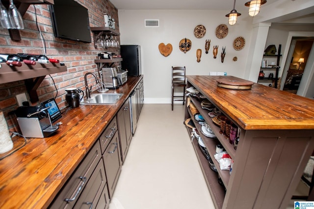 kitchen featuring visible vents, open shelves, baseboards, a sink, and wood counters
