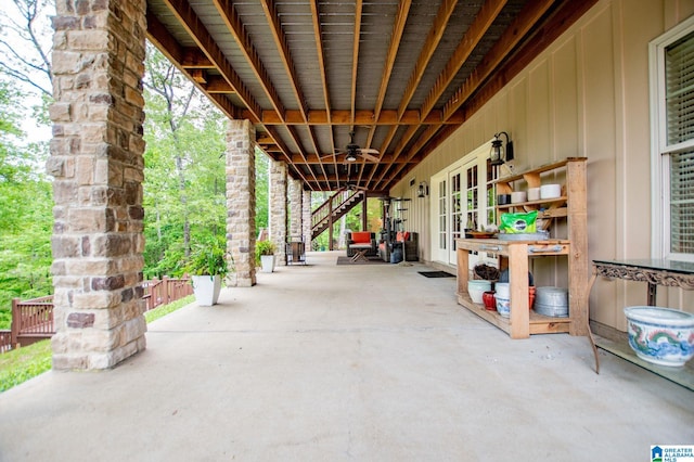view of patio / terrace with a ceiling fan and stairs