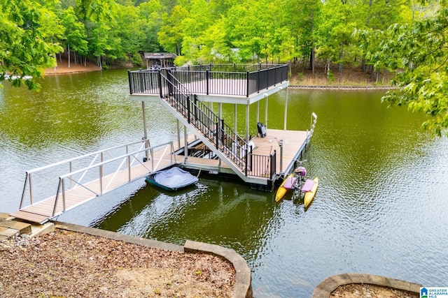 view of dock featuring a water view and a wooded view