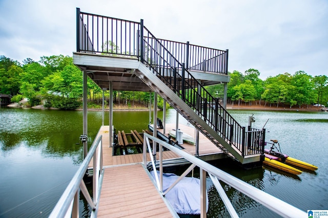 dock area with stairs, a water view, and boat lift