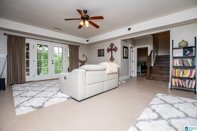 living room with visible vents, a ceiling fan, french doors, and stairway