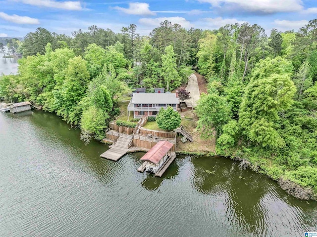 bird's eye view with a forest view and a water view