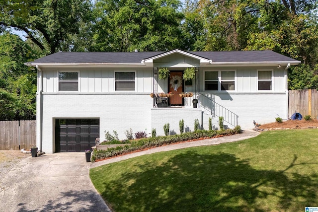 view of front facade featuring a garage, fence, board and batten siding, and brick siding