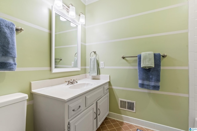 bathroom featuring vanity, baseboards, toilet, tile patterned flooring, and visible vents