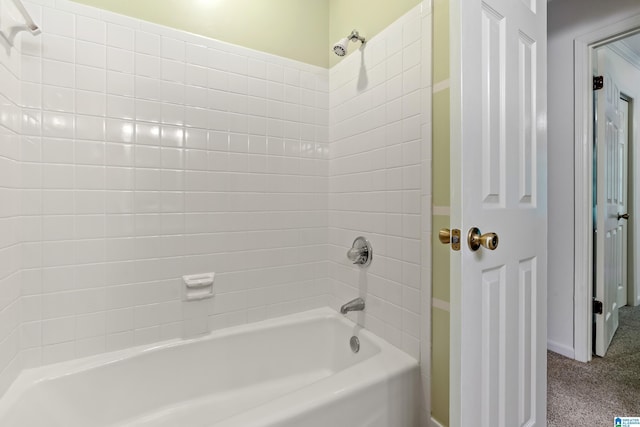 bathroom with baseboards and  shower combination