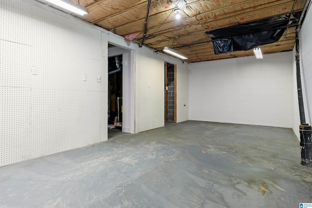 below grade area featuring concrete block wall