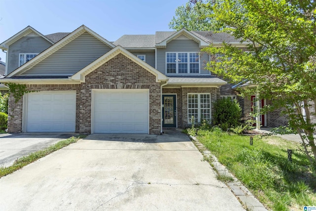 view of front of property featuring a garage, brick siding, and driveway