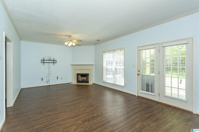 unfurnished living room with a fireplace with flush hearth, ornamental molding, ceiling fan, and dark wood-style flooring