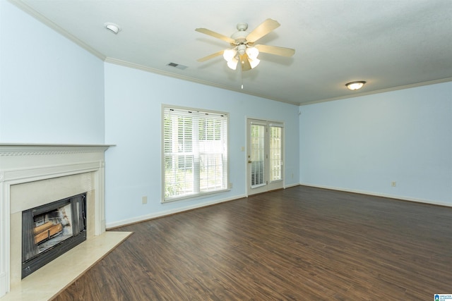 unfurnished living room with crown molding, visible vents, ceiling fan, a high end fireplace, and wood finished floors