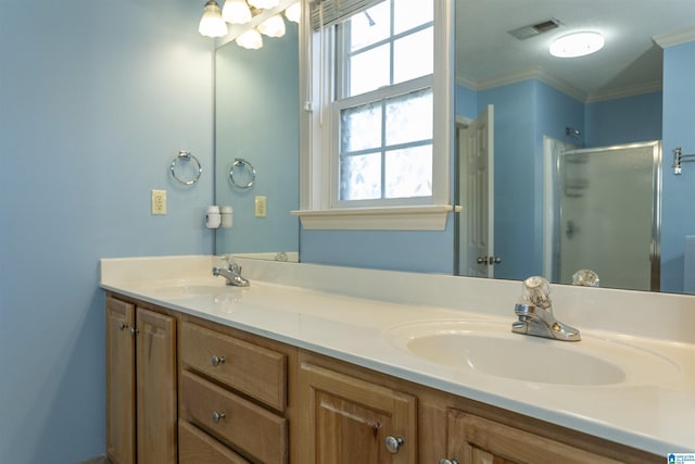 full bathroom featuring crown molding, a sink, a shower stall, and visible vents
