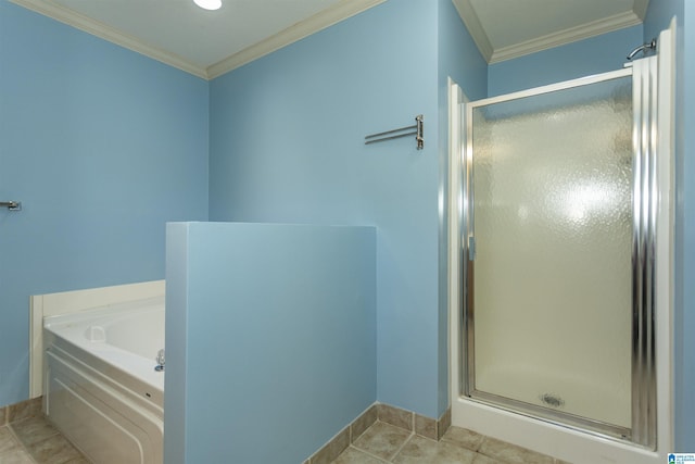 bathroom featuring ornamental molding, a stall shower, a garden tub, and baseboards