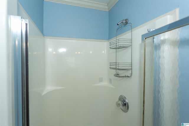 bathroom featuring walk in shower and crown molding