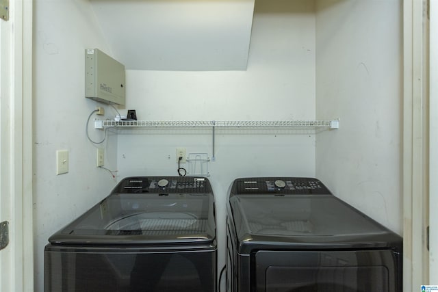 laundry room featuring separate washer and dryer and laundry area