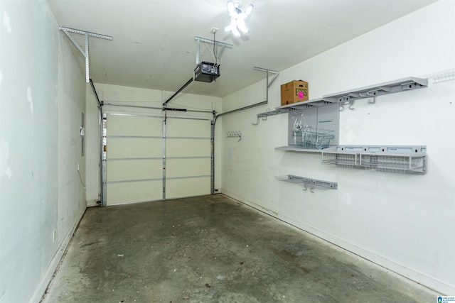 garage featuring a garage door opener and baseboards