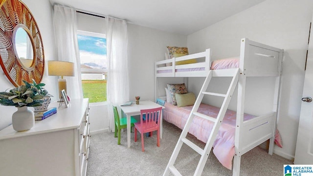 bedroom with baseboards and light colored carpet