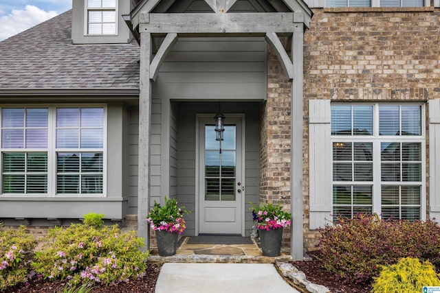 entrance to property with a shingled roof