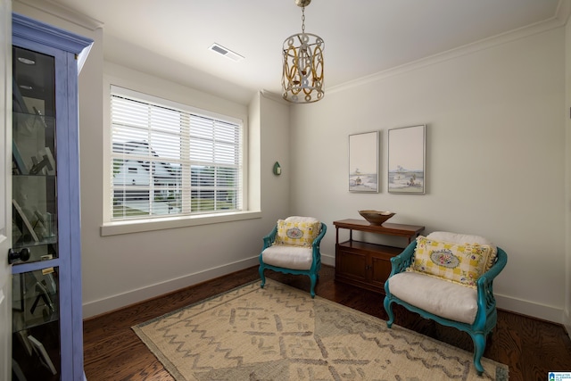 sitting room featuring an inviting chandelier, wood finished floors, visible vents, and baseboards