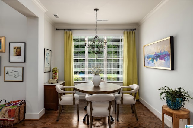 dining area featuring baseboards, ornamental molding, and an inviting chandelier