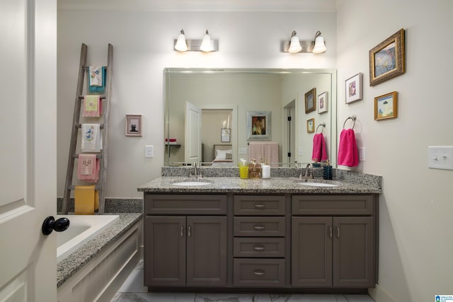 bathroom with a bath, double vanity, and a sink