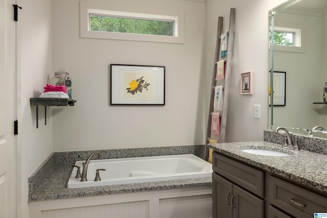 full bathroom featuring a bath and vanity