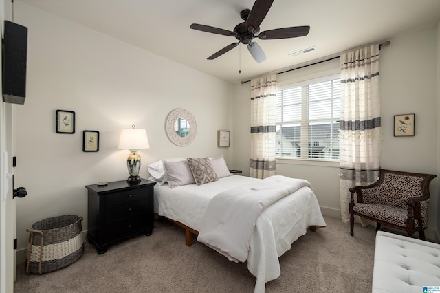 carpeted bedroom with visible vents and ceiling fan