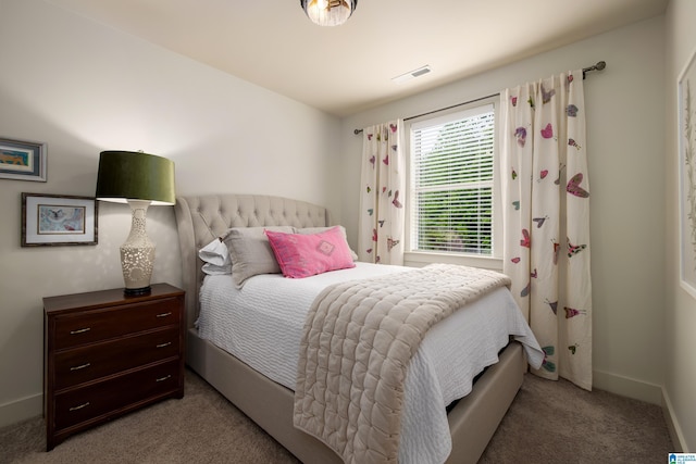 carpeted bedroom with visible vents and baseboards