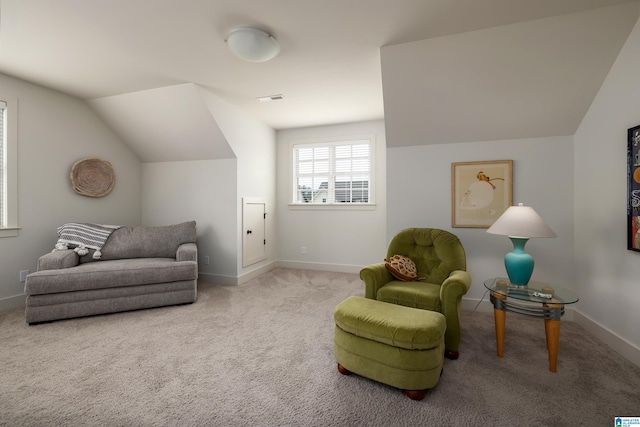 living area with baseboards, carpet, and vaulted ceiling