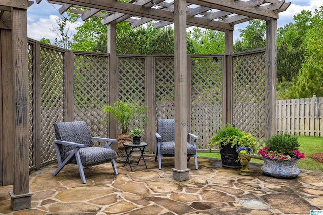 view of patio with a pergola and fence