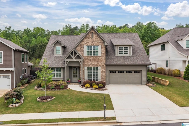 craftsman-style home with a garage, a shingled roof, driveway, and a front yard