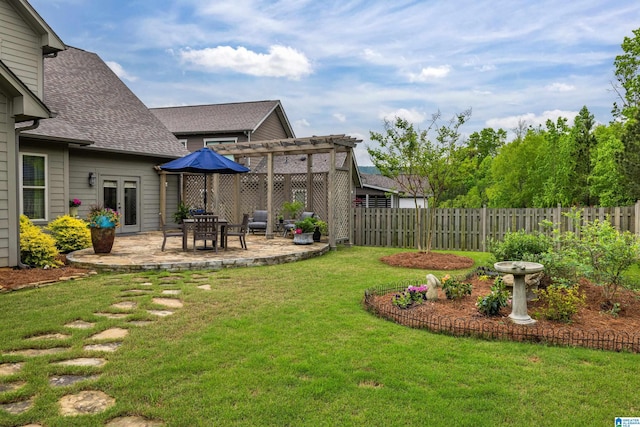 view of yard with fence, a patio area, french doors, and a pergola