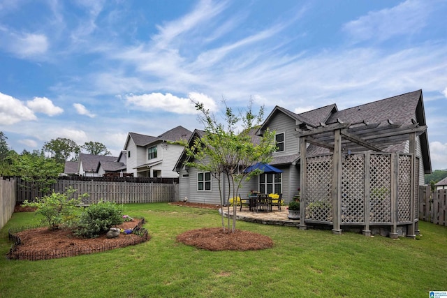 back of property featuring a fenced backyard, a shingled roof, a yard, and a pergola