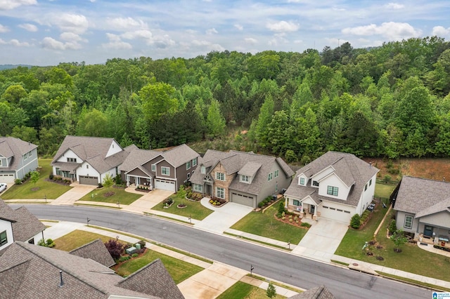 birds eye view of property with a wooded view and a residential view