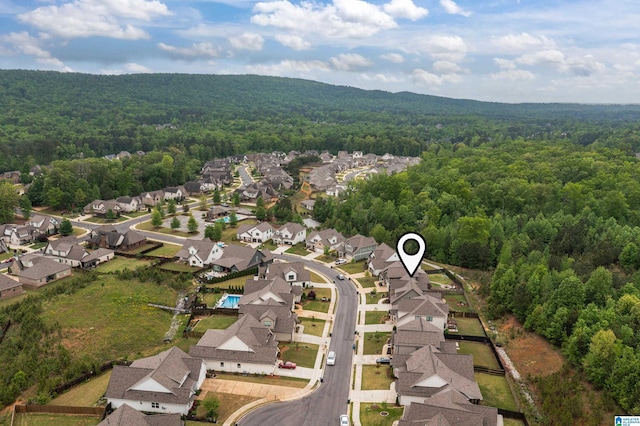 drone / aerial view with a residential view and a forest view