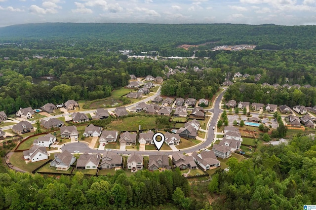 bird's eye view with a wooded view and a residential view