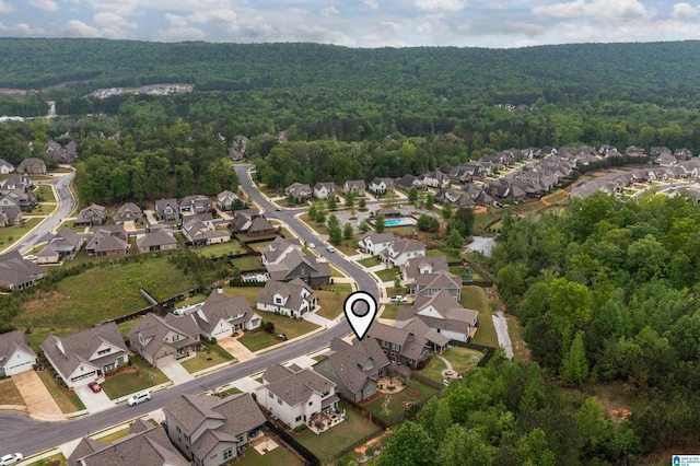 birds eye view of property with a residential view and a wooded view