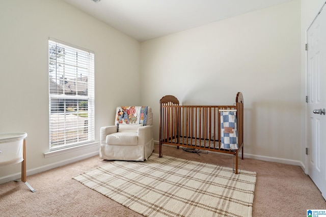 bedroom featuring baseboards, multiple windows, and carpet