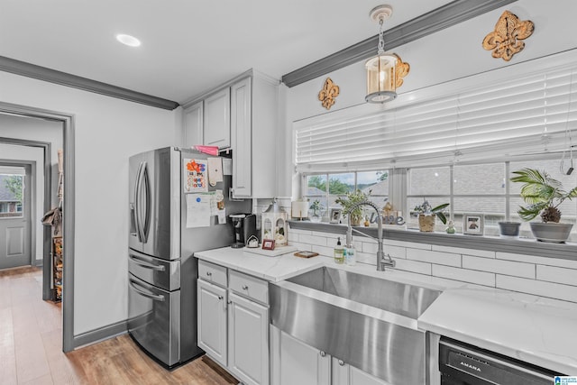 kitchen featuring dishwasher, stainless steel fridge with ice dispenser, crown molding, and a wealth of natural light