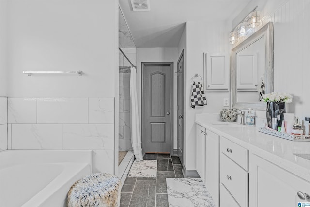 full bathroom featuring a bath, vanity, marble finish floor, visible vents, and tiled shower