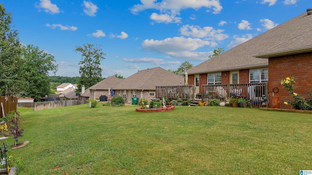 view of yard with a wooden deck and fence