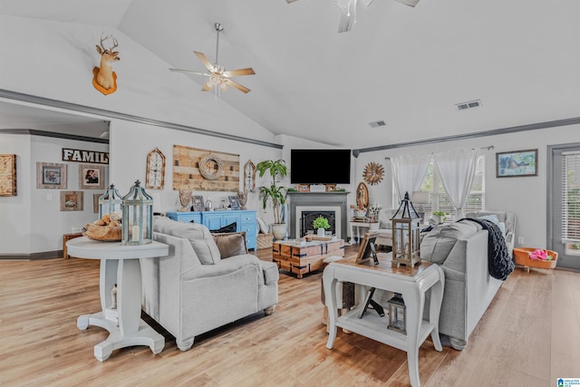living room featuring ceiling fan, visible vents, and light wood-style flooring