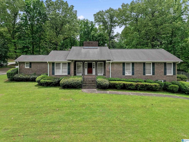 108 Dee Hendrix Rd, Hueytown, AL 35023 - ranch-style house featuring brick siding, a front lawn, and a chimney