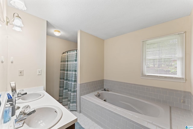 108 Dee Hendrix Rd, Hueytown, AL 35023 - bathroom featuring a bath, a sink, double vanity, and a textured ceiling