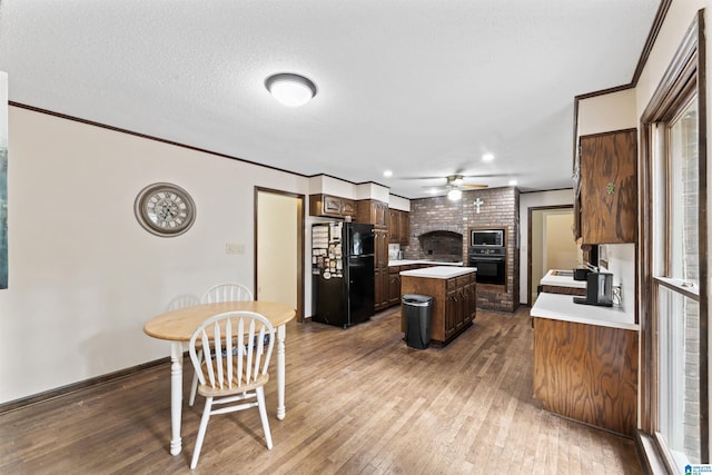 108 Dee Hendrix Rd, Hueytown, AL 35023 - kitchen featuring light countertops, a ceiling fan, crown molding, a center island, and black appliances