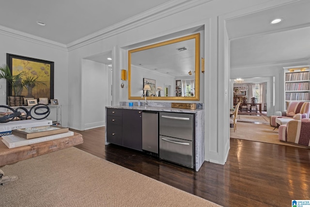 bar with crown molding, recessed lighting, bar, and dark wood-type flooring