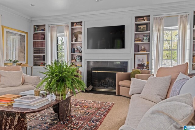 carpeted living room featuring a fireplace with flush hearth, crown molding, and built in shelves
