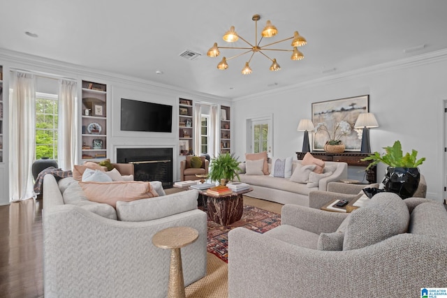 living room featuring a fireplace, a wealth of natural light, and crown molding